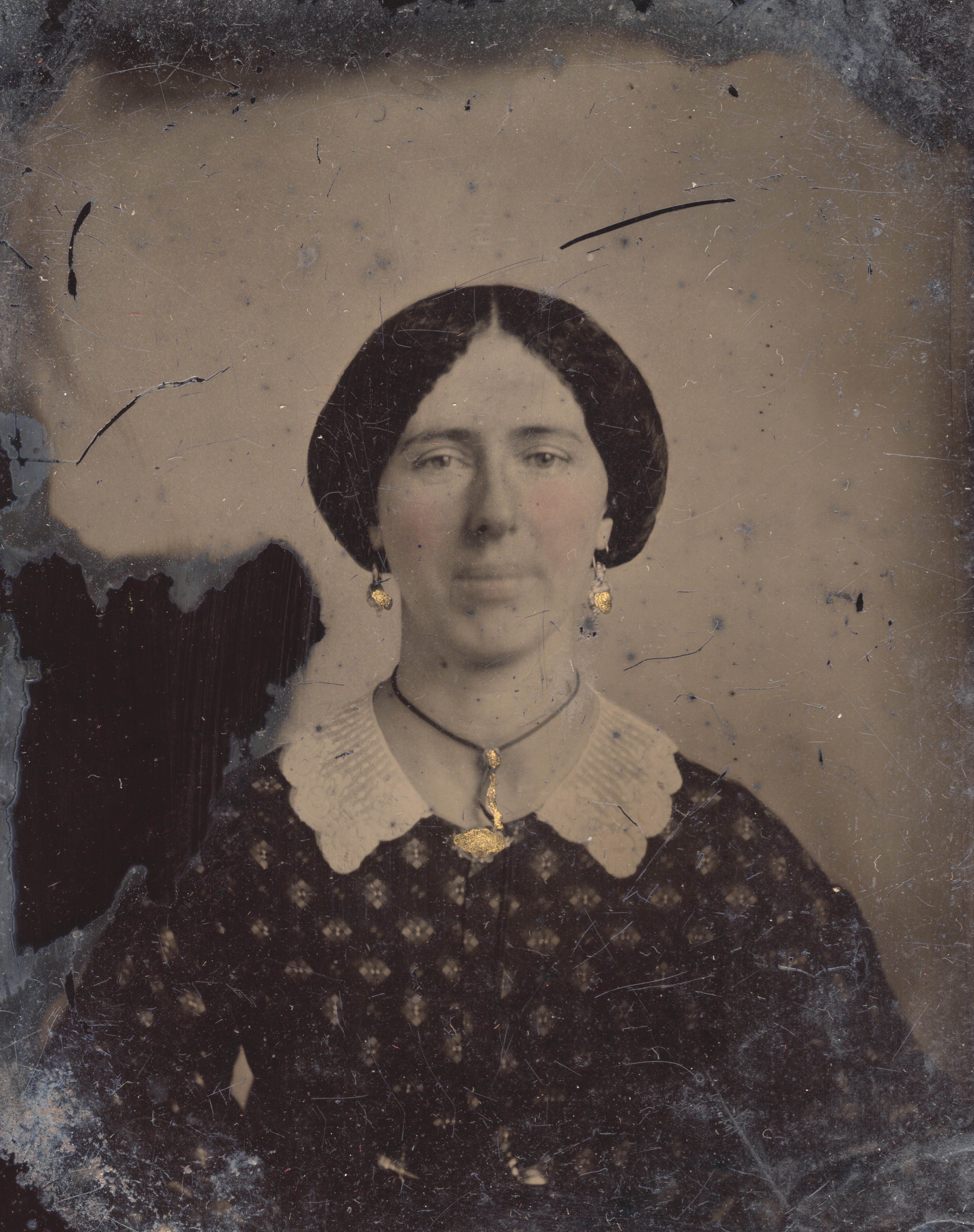 Woman with gold earrings and necklace